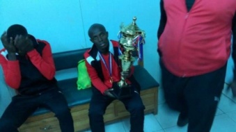 Francis Coffie poses with the league trophy
