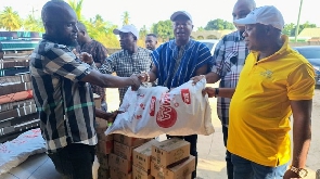 Wilmar Ghana Limited presenting the items to a representative of the Aflao Traditional Council