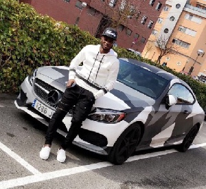 Mubarak Wakaso in front of his camouflage Benz