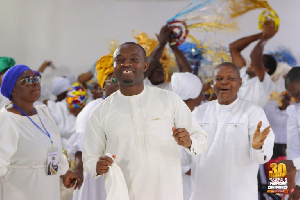 Evangelist Francis Awusi (Middle) with some church members