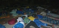 Students from participating schools lie on their mattresses in the open