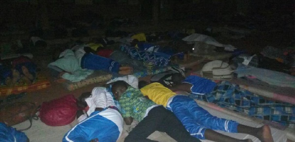 Students from participating schools lie on their mattresses in the open