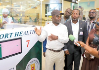 Health Minister Akandoh (in black cap) engages team through protocols