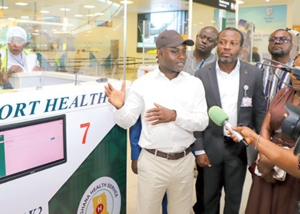 Health Minister Akandoh (in black cap) engages team through protocols