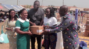 A nurse from a beneficiary hospital receives the medical items from Nana Yaa and Kojo Oppong Nkrumah