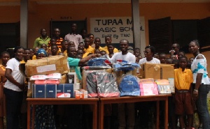 Staff of AirtelTigo read to the pupils and donated supplies to both schools in separate events