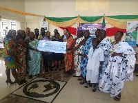 Officials of SSGL handing over the cheque to some elders of James Town