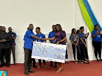 Aya Ayettey, Head of Production Assurance, Customer Care at Stanbic Bank presenting the cash prize