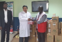 Dr Michael Agyekum-Addo (right) handing over the medicines to Dr Masoud Maleki Birjandi