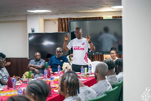 Kofi Adams (in white) addressing the team