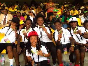 Black Queens take a group photo with medals
