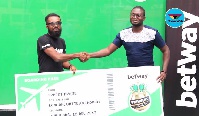 Ernest Nyame receives the package from a Betway Official