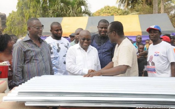 Nana Akufo-Addo presents items to victims