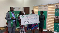 Dr. Ignatius Awinubonu (left) receiving a cheque in support of the programme