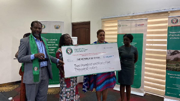 Dr. Ignatius Awinubonu (left) receiving a cheque in support of the programme