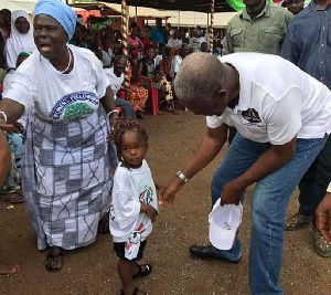Vice President, Kwesi Amissah-Arthur interacts with a chilld during his campaign.