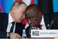 Russian President Vladimir Putin, left, speaks to South African President, Cyril Ramaphosa