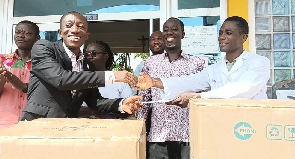 Official of Tobinco (left) donates the items to a rep of the hopsital