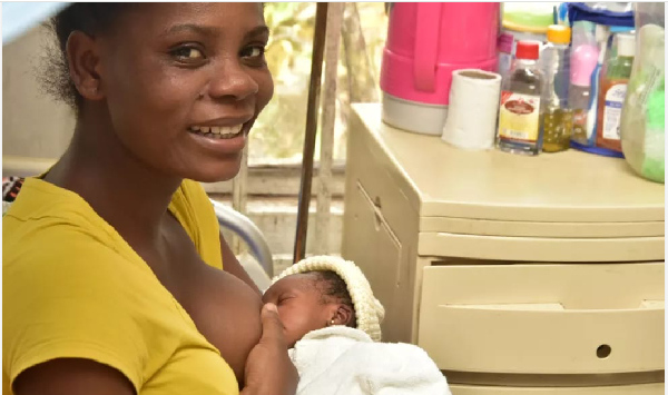 A mother is seen breast feeding her baby