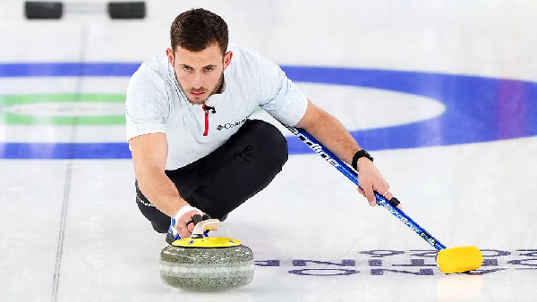 An athlete playing the icy ballet of stone