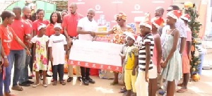 Vodafone Ghana presenting some items and cash to one of the orphanages they visited
