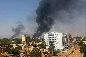 Smoke billows above residential buildings in Khartoum, during fighting in April 2023