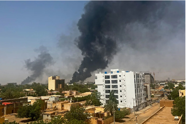 Smoke billows above residential buildings in Khartoum, during fighting in April 2023