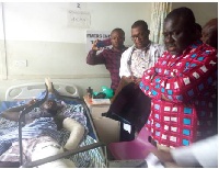 Kwaku Ofori Asiamah pictured with accident victim at the Trauma and Specialist Hospital, Winneba