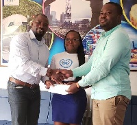 Daniel Nii Mensah hands over the cheque