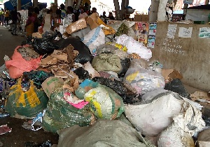 The space beneath the footbridge houses huge sacks of solid waste piled up like a mountain