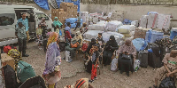 Sudanese refugees wait for buses at a station in Egypt's capital Cairo on May 13, 2025