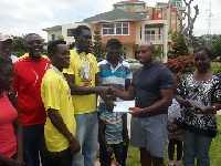 George Darko (Left) receiving his cheque from McCauley