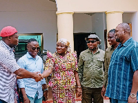 Selorm Mahama Dzramado (R) shaking hands with Victoria Amefadzi Yawa Doe (M) and other members