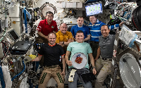The seven-member Expedition 74 crew gathers for a portrait