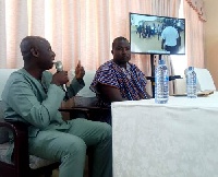 Sulemana (right) with his interpreter at the Commission hearing whilst the video is being shown
