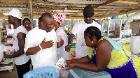 PPP Parliamentary candidate William Dowokpor interacting with some traders at the Santana market