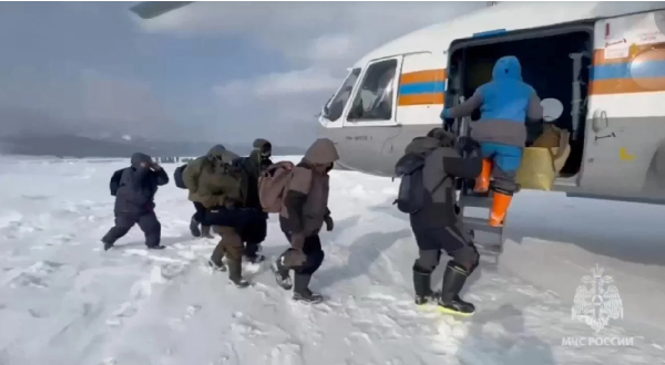 Fishermen stranded on an ice floe in the Sea of Okhotsk board a helicopter during a rescue operation