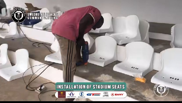 Some of the stadium seats getting fixed
