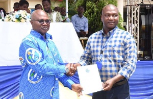 Dr Kingsley Ahenkora (left) presenting a certificate to one of the trainees