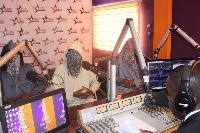 Masked faces of Anas and his colleagues in the studio of Starr FM