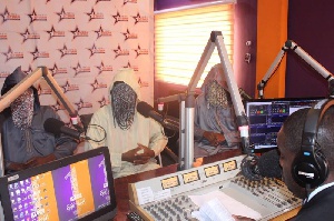 Masked faces of Anas and his colleagues in the studio of Starr FM