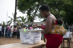 A mother voting during the 2020 general elections