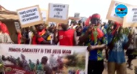 Residents clad in red protesting against the paramount chief for imposing undue authority over them