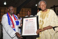 CK Tedam (R)being presented with citation for his meritorious service to the NPP by Afoko