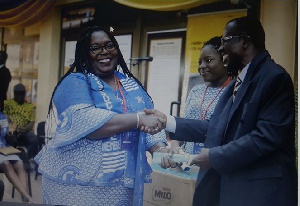 Mr. Kwadwo Asare-Bediako presenting a certificate to Mrs. Audrey Sasu Appiah, an Associate member