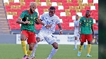 A Cameroonian player fends off an opponent