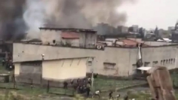 Footage from the jailbreak shows people fleeing from the building as black smoke rises into the air