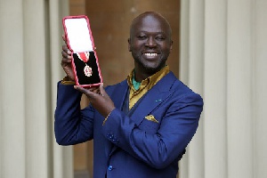 Sir David Adjaye poses after he was Knighted by the Duke of Cambridge