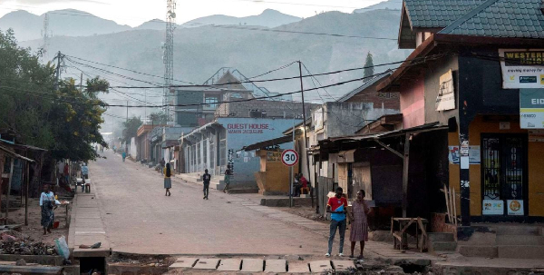 Civilians walk after returning to their homes following displacement during renewed clashes