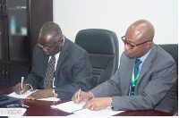 Martin Eson-Benjamin & Dr. Wilfred Anim-Odame signing the IEA between MiDA and Lands Commission